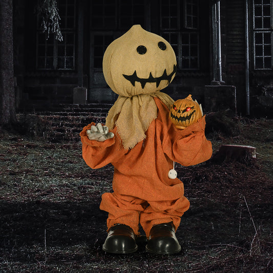 the Halloween scarecrow decoration standing in a dark, outdoor setting at night