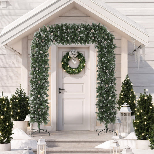 The artificial Christmas tree arch decorated on a house doorway with a wreath and outdoor lights