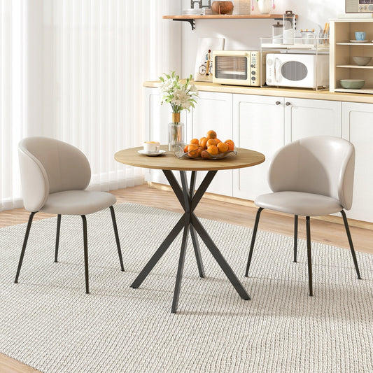 The round dining table set with two chairs in a bright kitchen dining area