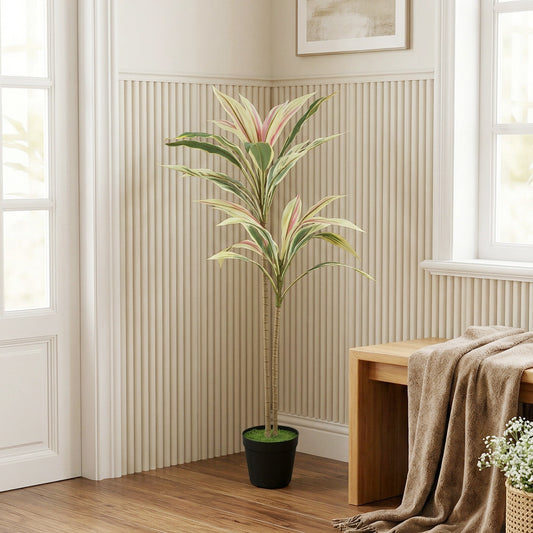 Artificial cordyline tree in a black pot placed in a living room next to a wooden bench
