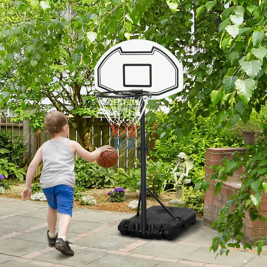 A young boy playing with the adjustable height basketball hoop and stand in a garden