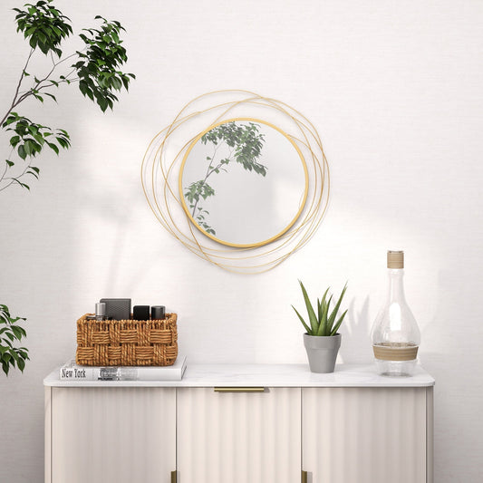 Abstract metal wire wall mirror hanging above a console table with decorative items