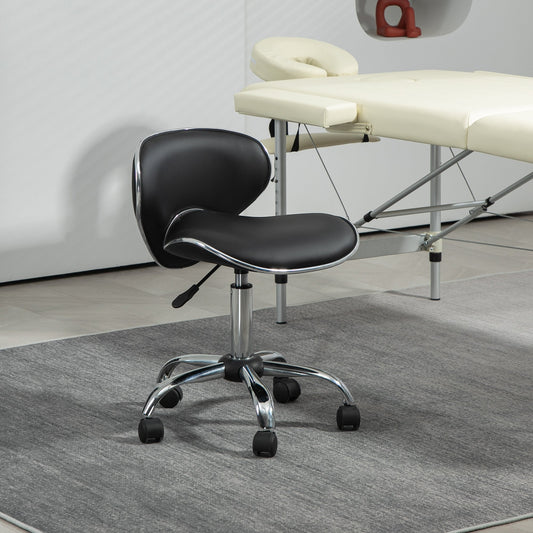 Black beauty salon chair in a room next to a massage bed