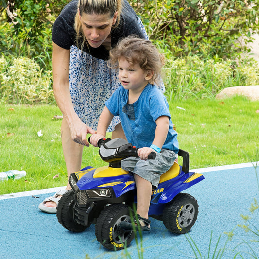 A woman helps a young child ride the blue and yellow quad bike in a garden setting