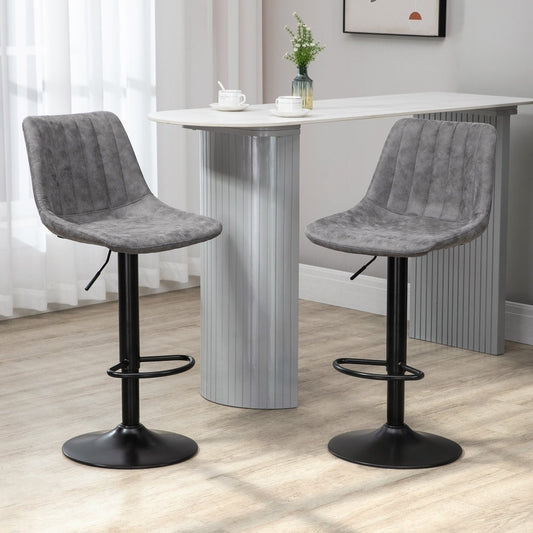 The bar stools placed in a modern kitchen setting next to a white breakfast bar table