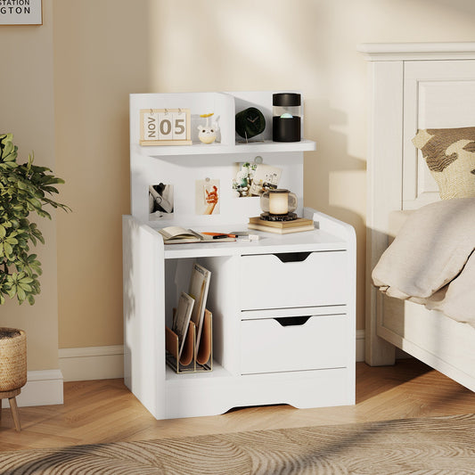 The storage cabinet styled in a bedroom next to a bed with books and decor on the shelves