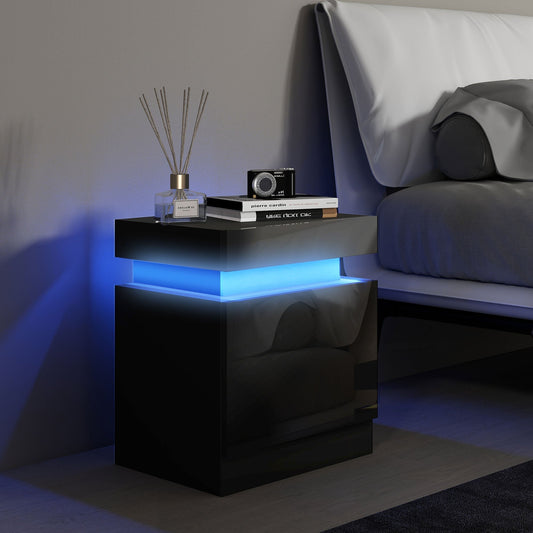 The black bedside table with LED light shown next to a bed with a book and diffuser on top