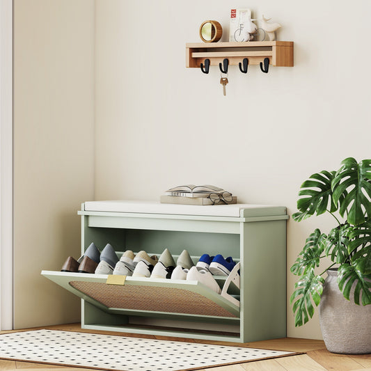 The shoe storage bench in a hallway with one flip-down drawer open, holding several pairs of shoes