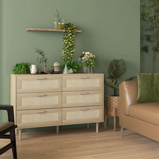 A six-drawer dresser unit with rattan fronts placed in a stylish living room next to a sofa