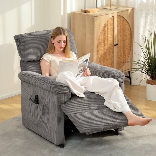 A woman sitting in the grey massage chair reading a book in a living room