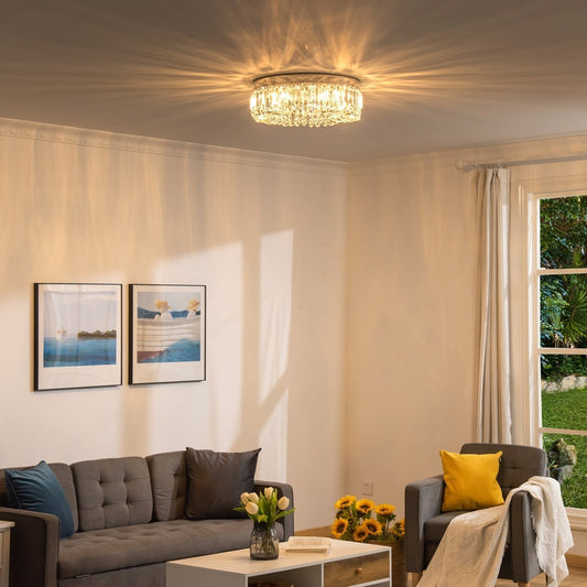 The crystal ceiling light illuminating a living room with a sofa and armchair