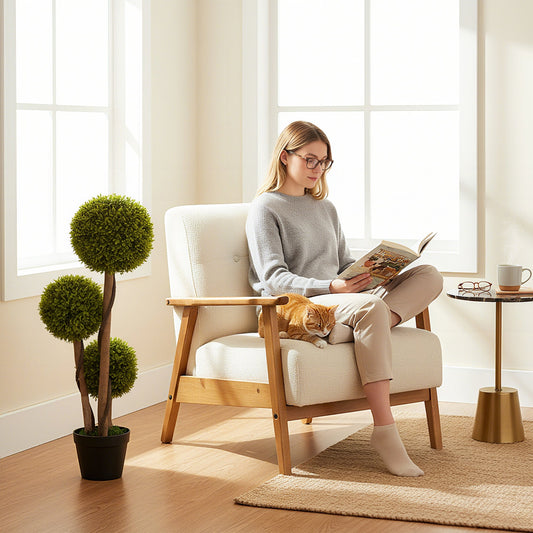 The artificial plants placed in a bright living room next to a comfortable armchair