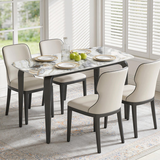 The dining table with four chairs around it in a light room setting