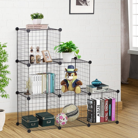 The black metal wire storage cabinet filled with books and ornaments in a room