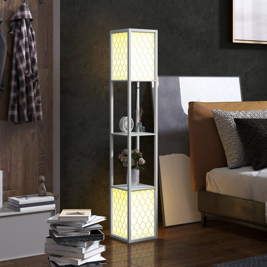 The white floor lamp with shelves lit up in a bedroom setting next to a bed and stack of books