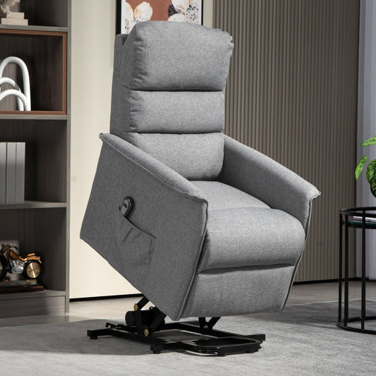 The grey electric riser armchair is shown in a living room with a bookshelf and side table