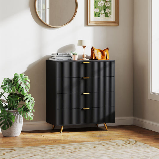 Black four-drawer chest of drawers in a stylish bedroom setting next to a plant and lamp