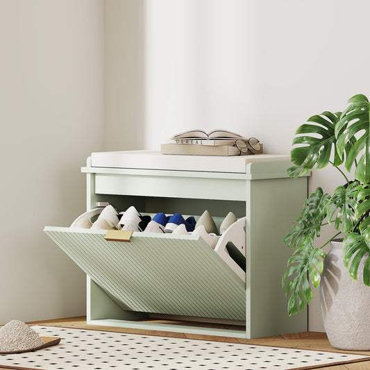 The shoe storage unit placed in a bright room with shoes inside and a plant beside it