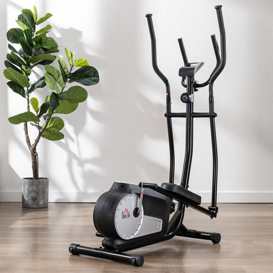 Black elliptical cross trainer in a domestic setting next to a potted plant
