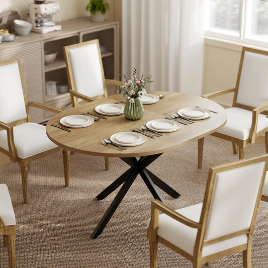 The dining table set for dinner with chairs in a bright modern living room setting