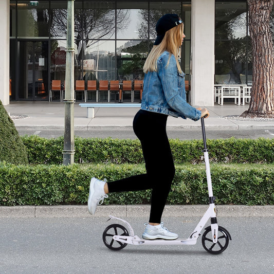 The urban scooter being ridden by a young woman on a paved outdoor path