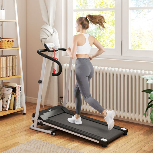 A woman running on the grey walking pad treadmill in a bright room