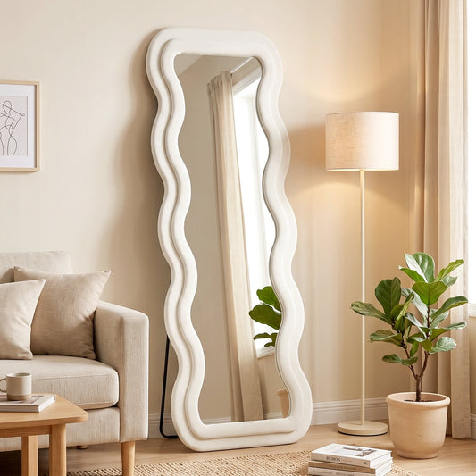 The full length mirror standing in a bright living room next to a floor lamp and a sofa