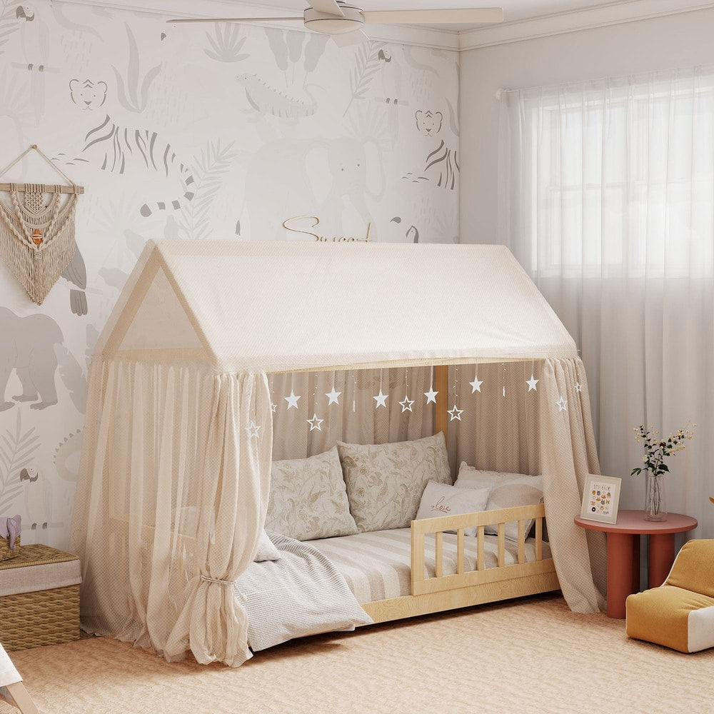 The house-shaped kids bed frame with a fabric canopy draped over it in a child's bedroom