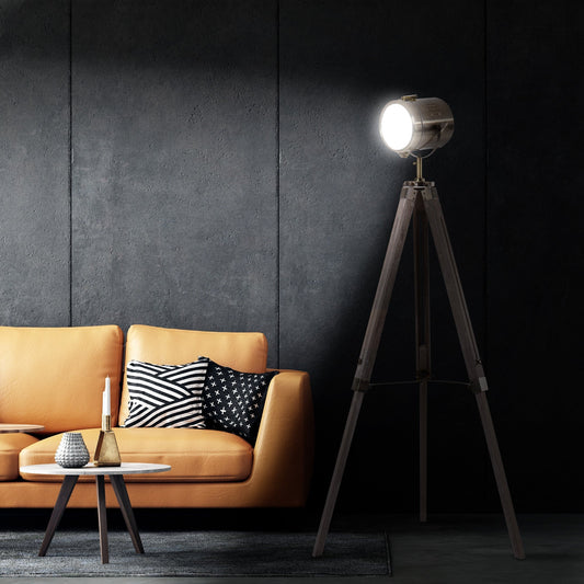 The industrial tripod floor lamp in a modern living room next to a sofa