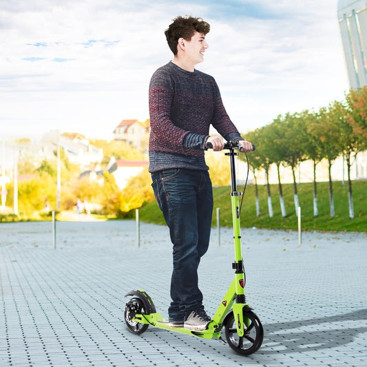 A green two-wheel scooter being ridden by a teenage boy on a paved path