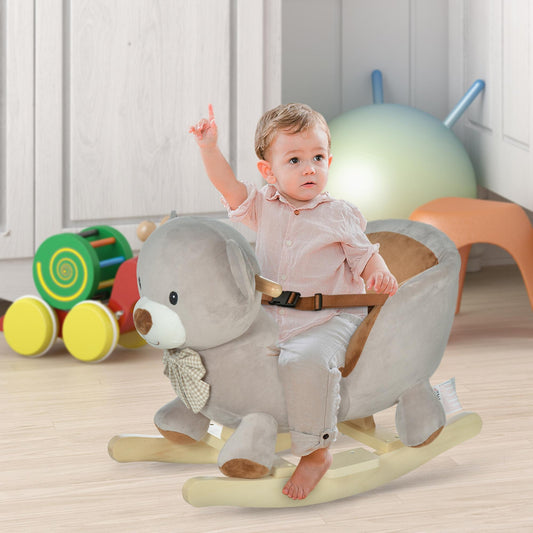 A baby sits safely secured in the plush bear rocking animal