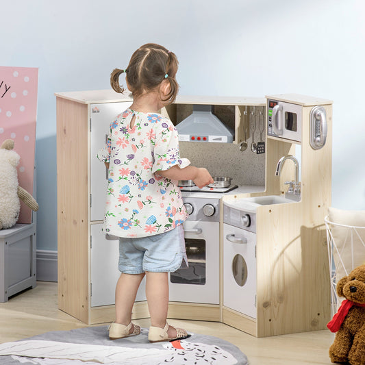 A child plays with the wooden kitchen playset, which includes an oven, hob and sink