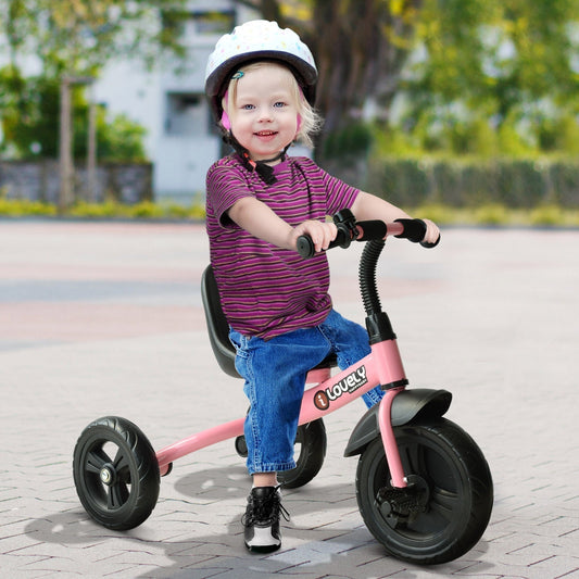 A young child wearing a helmet rides the pink tricycle outdoors on a paved surface