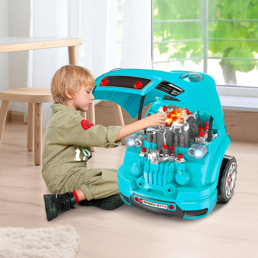 Young boy playing with the teal kids truck engine toy set, opening the bonnet