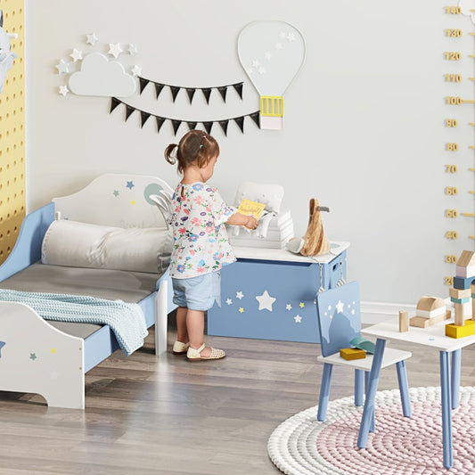The blue toy chest is in a child's room with a small table and chair next to it