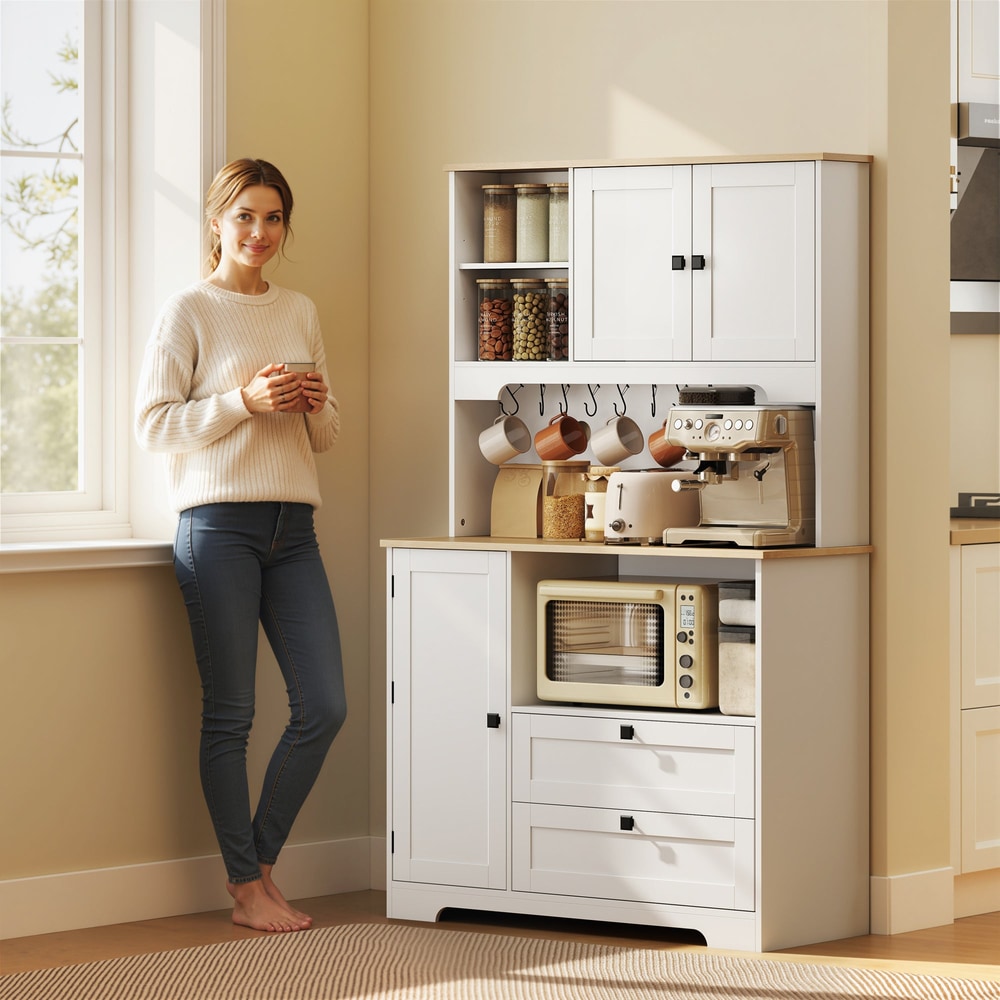 A woman stands next to the white kitchen cabinet in a bright room