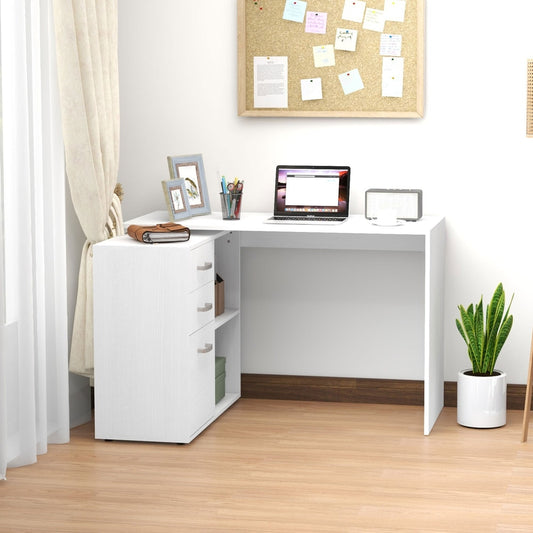 The white L shaped computer desk set up in a home office with a laptop and plant
