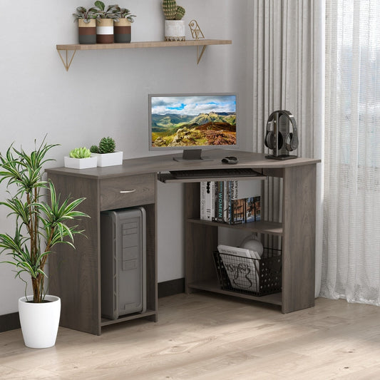 Grey L-shaped computer desk in a home office setting with plants and shelving
