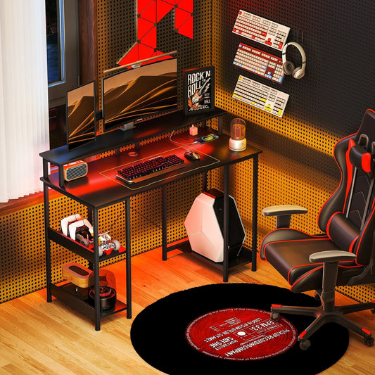 The office desk is set up in a gaming room with two monitors, a keyboard and a gaming chair