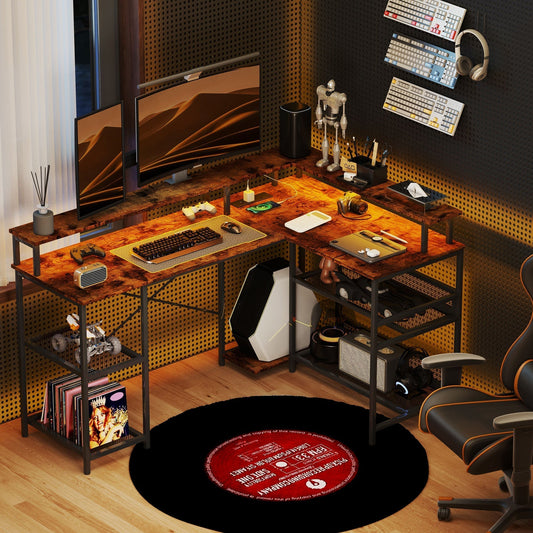 The L-shaped computer desk is set up in a room with two monitors, a computer tower, keyboard, mouse and gaming chair