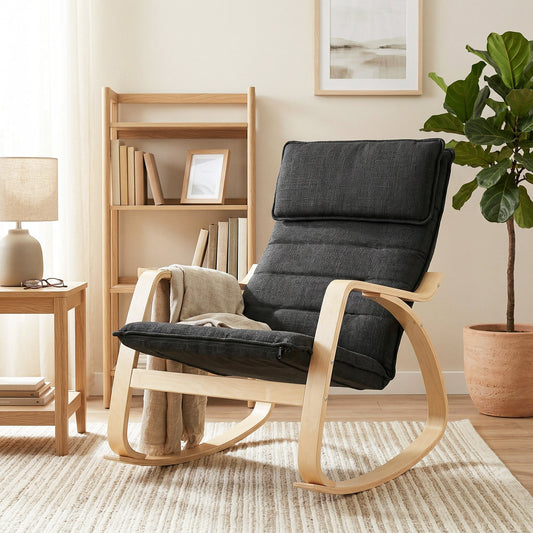 The rocking chair with a black padded seat and light wood curved frame in a room