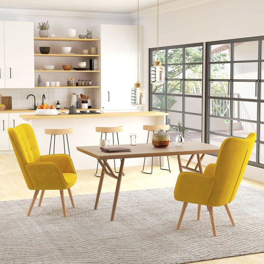 Two yellow wingback armchairs placed at a wooden dining table in a bright modern kitchen