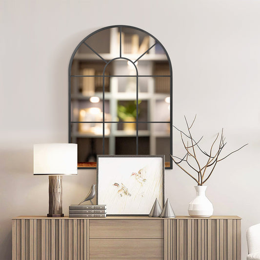 The arched wall mirror is displayed above a sideboard in a stylish room setting