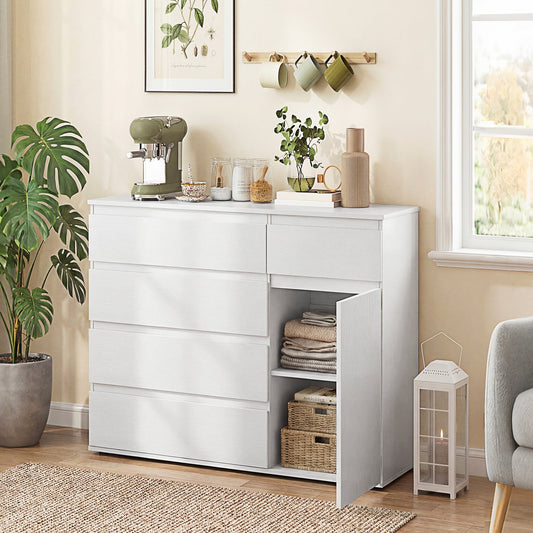 The storage cabinet placed in a living room with the cupboard door open showing folded clothes