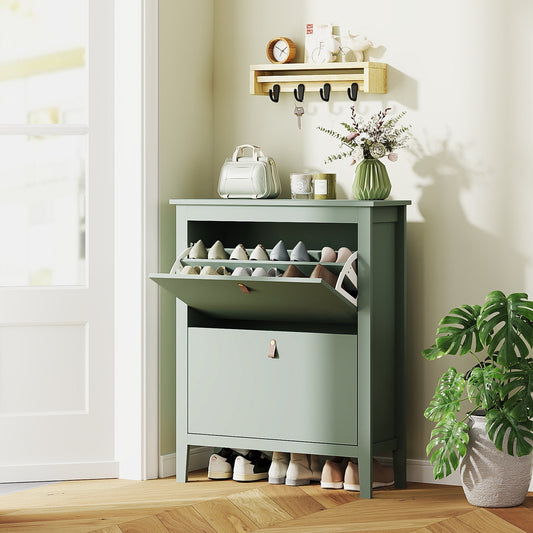 Green shoe storage cabinet with its top drawer open, showing shoes inside, in a hallway setting