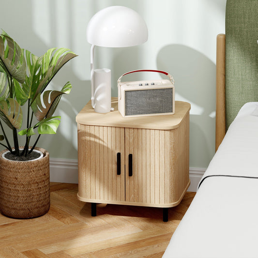 The oak tone storage cabinet is shown next to a bed with a lamp and radio on top