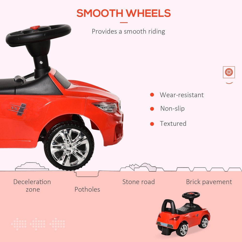 Close up of the red ride-on car showing smooth wheels and different road surfaces