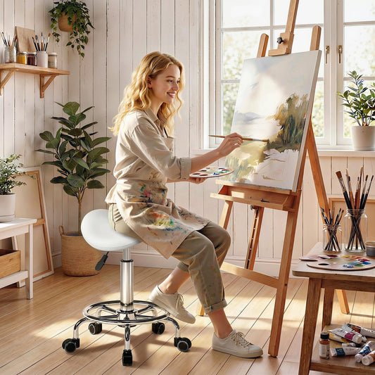 The stylist stool being used by a woman painting on a canvas in a bright art studio