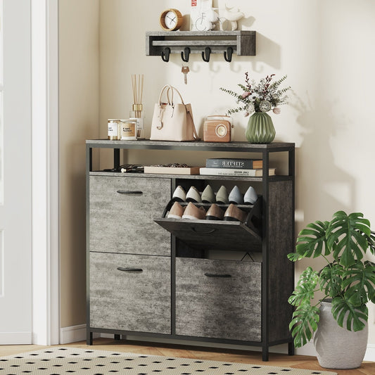 The shoe storage cabinet in a hallway with items on top and shoes inside the flip drawers
