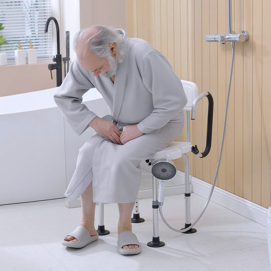 An elderly man sitting on the shower stool inside a modern bathroom setting